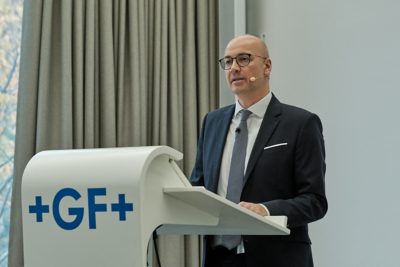GF CEO Andreas Müller presenting at a podium