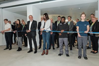 Many people crowded around for the cutting of the ribbon at the ceremony at GF Piping Systems, Schaffhausen