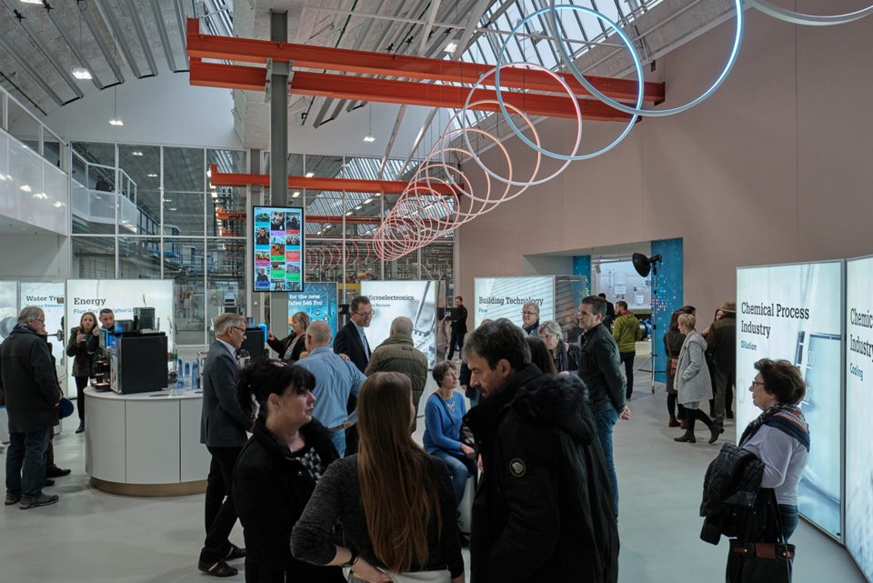 People looking around the showroom at the different training stalls at GF Piping Systems Schaffhausen