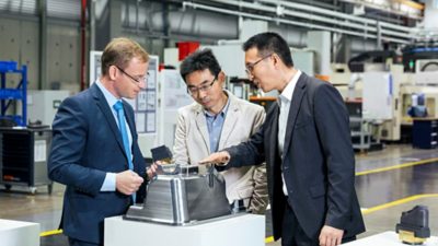 Steffen Dekoj, Wang Xuefeng, and Daniel Hu (from left to right) agree: "The partnership is successful because both sides put great value on commitment and efficiency." (Photo: Bakas Algridas)