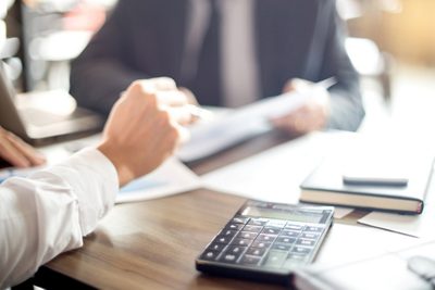Businessman work with computer on table in office work with paper graph chart business marketing plan analysis 