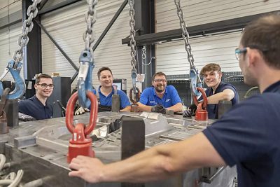 Instructor demonstrates die casting process to students.