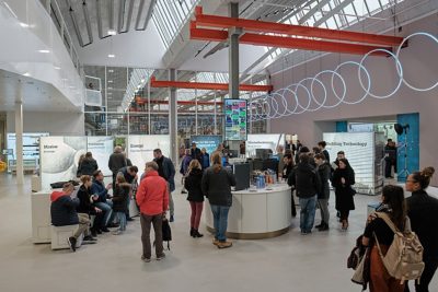 People looking around the showroom at the different training stalls at GF Piping Systems Schaffhausen