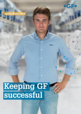 Cover image from the 2018 annual report, showing a man in GF uniform standing in a production facility