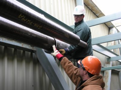 Men Installing insulated pipe