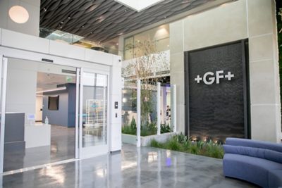 A stylish and serene lobby space featuring cozy seating and natural greenery—setting the tone for a productive day.