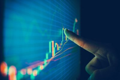 Closeup hand pointing finger on blue color monitor to analyze stock market graph, Closeup hand pointing finger on blue color monitor to analyze st