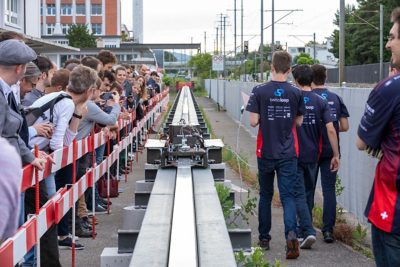 Students from ETH Zurich demonstrating their invention to onlookers on an outdoor track